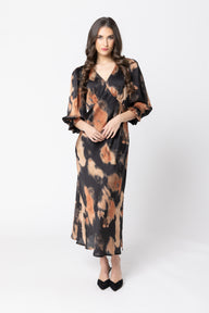 Woman wearing a patterned dress on a white background