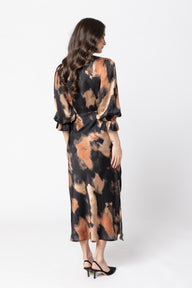 Woman wearing a tie-dye dress on a white background
