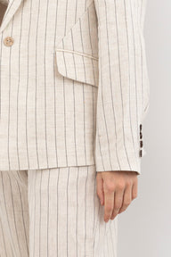 Beige pinstripe suit with a white background