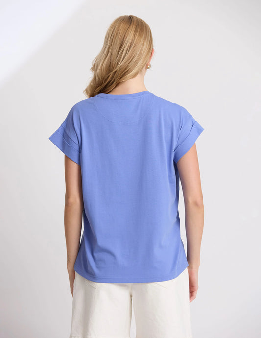 Person wearing a blue t-shirt on a plain background