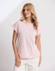 Woman wearing a light pink t-shirt against a white background
