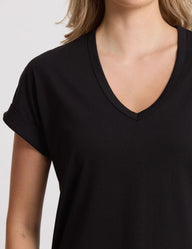 Black V-neck t-shirt worn by a person on a light gray background