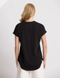 Person wearing a black t-shirt on a plain background
