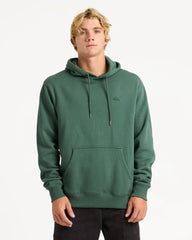 Person wearing a green hoodie with a brand logo on a white background