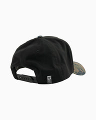 Black cap with a brand logo on a light gray background