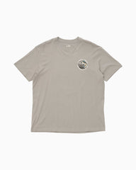 A light gray short-sleeve crewneck t-shirt with a small circular graphic printed on the left chest, displayed flat against a light gray background.