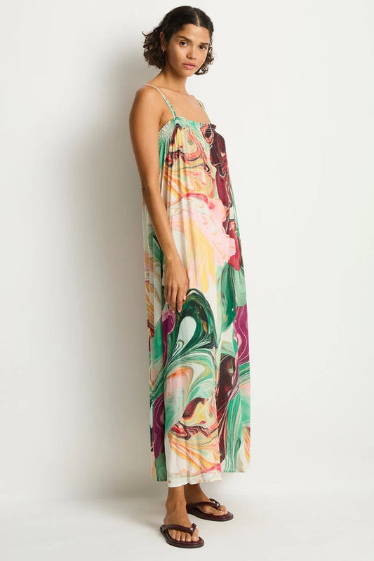 Woman wearing a colorful floral dress on a white background