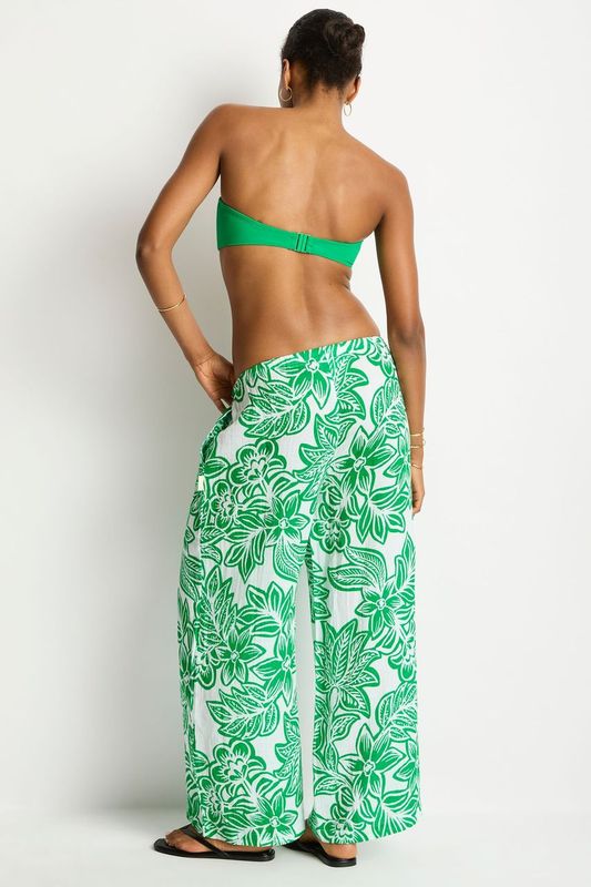 Person wearing a green floral outfit on a white background