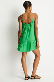 Woman wearing a green dress against a white background