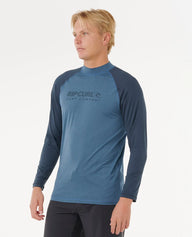 Man wearing a blue and navy Rip Curl shirt on a white background