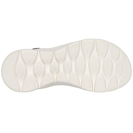 Close-up of a white shoe sole with tread pattern on a white background