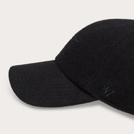 Two black baseball caps on a light gray background