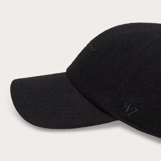 Two black baseball caps on a light gray background