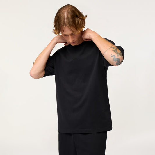 Person wearing a black t-shirt and pants on a white background