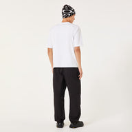 Person wearing a white t-shirt and black pants on a white background