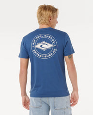 Man wearing a blue t-shirt with a logo on the back against a white background
