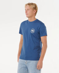 Man wearing a blue t-shirt with a logo on a white background