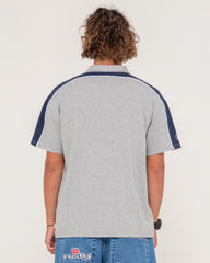 Person wearing a gray polo shirt with navy accents on a plain background