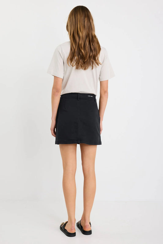 Person wearing a black skirt and white shirt on a white background