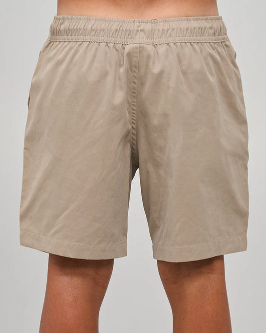 Beige shorts worn by a person on a plain background