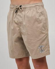 Beige shorts with a logo on a plain background
