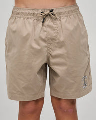 Beige shorts with a logo on a plain background