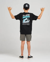 Person wearing a black t-shirt with a shark graphic and text, standing against a plain background