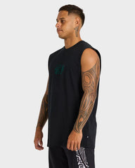 Man wearing a black sleeveless shirt with a logo on a white background