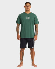 Man wearing a green t-shirt and black shorts on a white background