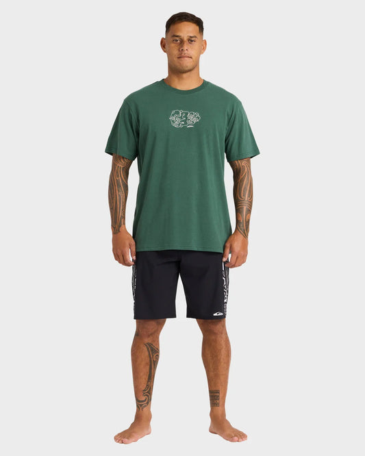 Man wearing a green t-shirt and black shorts on a white background