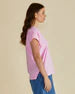 Woman wearing a pink t-shirt with a blue background