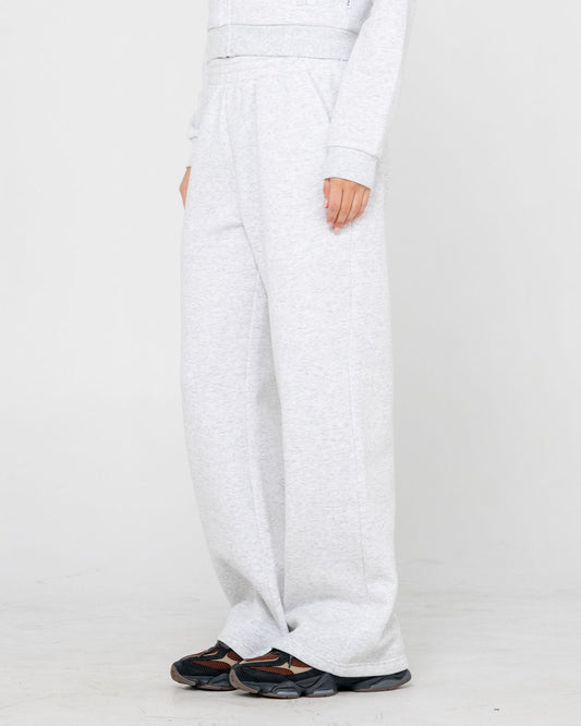 White pants worn by a person on a white background