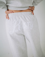 Gray sweatpants with a brand logo on a plain background