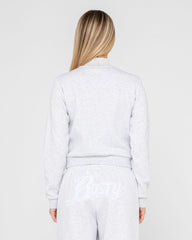 Person wearing a light gray outfit on a white background