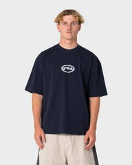 Person wearing a navy blue t-shirt with a logo on a white background