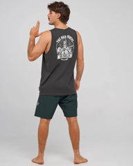 A man wearing a dark gray sleeveless t-shirt with a white graphic print on the back and dark green athletic shorts, standing against a light gray studio background.