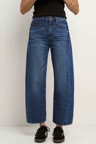 Person wearing blue jeans on a white background