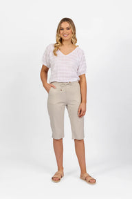 Woman wearing Vassalli Below Knee Skinny Leg Elastic Waist Pant in stone with white top and white background