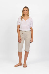 Woman wearing Vassalli Below Knee Skinny Leg Elastic Waist Pant in stone with white top and white background