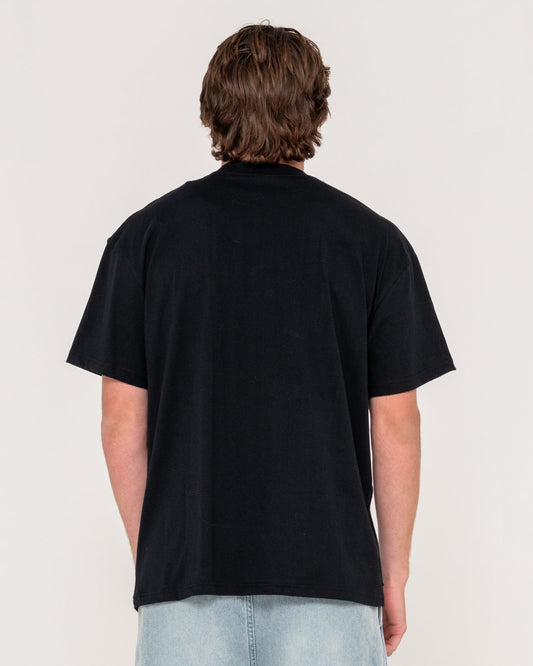 Person wearing a black t-shirt on a plain background