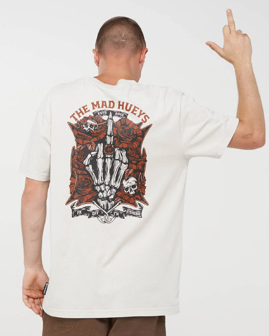 A man shown from the back wearing a white t-shirt with a large graphic print on the back. The graphic features a skeleton hand holding a knife, skulls, roses, and the text 'THE MAD HUEYS' in red and black.