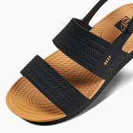 Black and brown sandal with 'Reef' branding on a white background