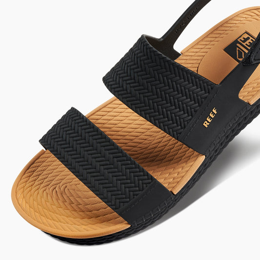 Black and brown sandal with 'Reef' branding on a white background