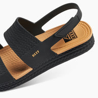 Black and brown sandal with 'REEF' branding on a white background