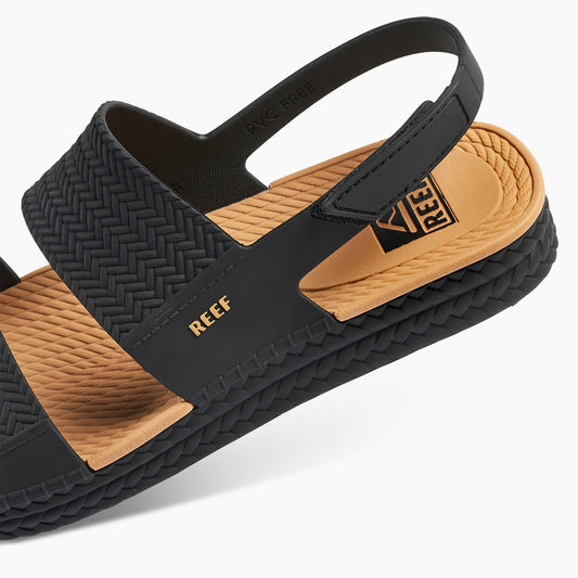 Black and brown sandal with 'REEF' branding on a white background