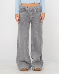 Person wearing gray wide-leg jeans on a white background