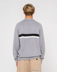Person wearing a gray sweater with a black and white stripe on a light gray background