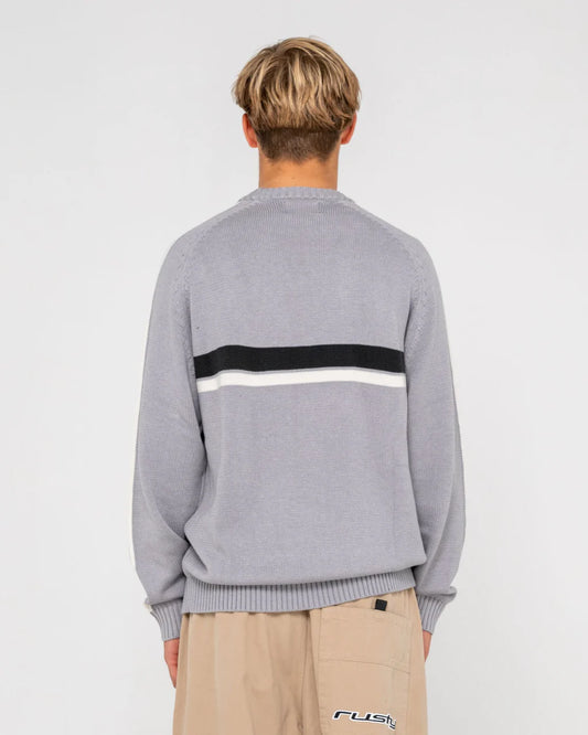 Person wearing a gray sweater with a black and white stripe on a light gray background
