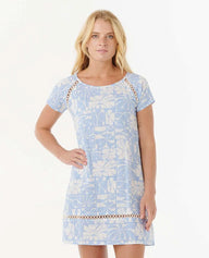 Woman wearing a light blue floral dress with lace details on a white background
