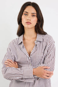 Woman wearing a striped shirt against a white background